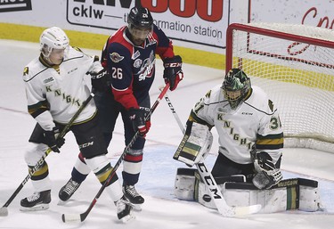 London Knights goalie Jordan Kooy makes a save while teammate Adam Boqvist ties up Cole Purboo of the Windsor Spitfires during game 4 of their playoff series on Thursday, March 28, 2019 at the WFCU Centre in Windsor, ON. (DAN JANISSE/The Windsor Star)