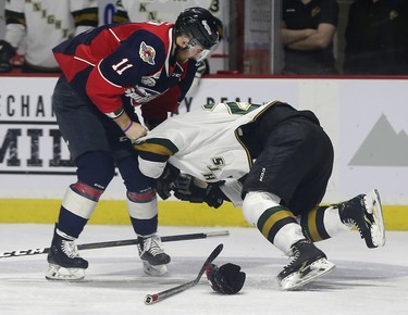 Sean Allen, left, of the Windsor Spitfires roughs up Avan Bouchard of the London Knights during game 3 of their playoff series at the WFCU Centre in Windsor, ON.  (DAN JANISSE/The Windsor Star)