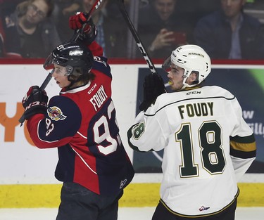 Brothers Jean-Luc Foudy, left, of the Windsor Spitfires and Liam Foudy of the London Knights get tied up during game 4 of their playoff series on Thursday, March 28, 2019 at the WFCU Centre in Windsor, ON. (DAN JANISSE/The Windsor Star)
