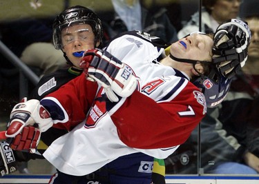 London Knight Tony DeHart roughs up Cory McGillis of the Windsor Spitfires during their OHL game at the John Labatt Centre in London, Ontario on Friday, December 15, 2005. DeHart received a minor penalty on the play.