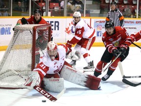 Soo goaltender Matthew Villalta jumps on a loose puck while (left to right) Adam McMaster, Morgan Frost and Cade Robinson lurk around the net as the Owen Sound Attack host the Sault Ste. Marie Greyhounds in Game 4 of their Western Conference quarterfinal series inside the Harry Lumley Bayshore Community Centre Wednesday night. Greg Cowan/The Sun Times.