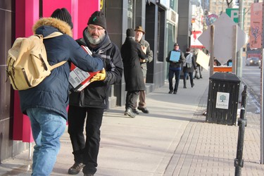 Close to 50 people gathered in downtown London Monday morning, forming a human chain to help the owners of Brown & Dickson Book Shop move close to 200 boxes with books to their new home. (JONATHAN JUHA, The London Free Press)