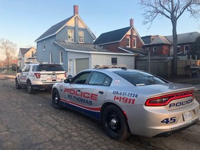 A pair of St. Thomas police cruisers are seen Wednesday morning on St. Catharine Street, north of Talbot Street, as police investigate an attack that sent one man to hospital with serious injuries. (St. Thomas police handout)