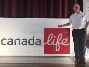 Jeff Macoun, president of what has been known as London Life, stands with a sign at a media event on April 3, 2019 where the insurer announced its rebranding as Canada Life. (NORMAN DeBONO, The London Free Press)