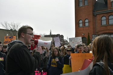 Mason Cox, a Grade 10 student at College Avenue secondary school and one of the main organizers, addresses the crowd near Oxford MPP Ernie Hardeman's Woodstock office Thursday. Students from Woodstock's high schools walked out of classes in the afternoon as part of a provincewide protest against education cuts by the Ontario government. KATHLEEN SAYLORS/ENTINEL-REVIEW