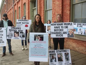 Jessica Robinson, centre, stands with supporters Friday afternoon during a stand-in at the office of Jeff Yurek, MPP for Elgin-Middlesex-London. Robinson is campaigning for reforms to provincial jails where she says people are losing their lives due to lack of emergency response from staff. (Laura Broadley/Times-Journal)