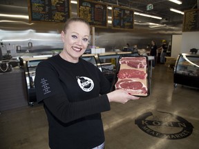 Owner Laura Cakarnis holds cuts of meat in the new location of Kohn Meat Market. The butcher store that's been in business for more than 60 years recently reopened on Hamilton Road after water damage forced it to move from its original location at Egerton and Trafalgar streets. (Derek Ruttan/The London Free Press)