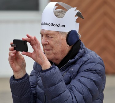 Robert Pope, of Etobicoke, donned a swan hat while taking video of the swan parade, which he attended for the first time with his Mitchell-born wife, Eleanor. (Cory Smith/The Beacon Herald)