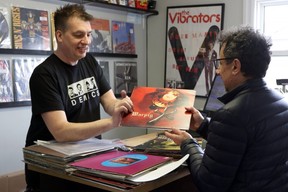 Speed City Records Mike Todd, left, and customer Boris Pantic look at a Warpig record in his store Thursday, April 11, 2019. Record Store Day will take place Saturday, April 13 with regional record stores expecting busy days. (Greg Colgan/Woodstock Sentinel-Review)