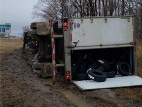A transport truck rolled Sunday on Highway 401 near Dutton, southwest of London. Police say the truck had been stolen and the driver fled the scene of the crash after the collision. (Elgin OPP handout)