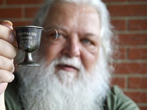 Mike D'Amico holds a refurbished 1926 trophy from the all-girls Camp Tanamakoon in Algonquin Park. He says he's going to ship the old trophy back to the camp before long, for them to put with their historic collection. (Louis Pin/The Observer)