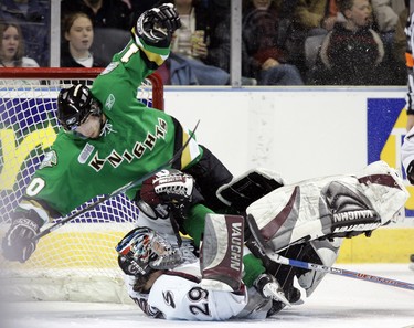 MACDONALD DRIVE THROUGH - London Knights (in Green) Vs. The Guelph Storm in OHL action at the John Labatt Centre,  Knight's Josh Beaulieu flies over Storm goalie Ryan MacDonald during first period action.n/a