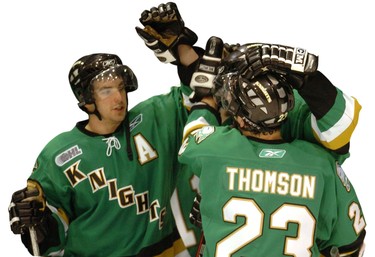 Knights including Dylan Hunter, left, and Kelly Thomson celebrate after beating Guelph.