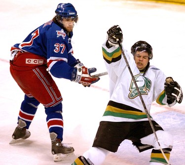 Kitchener forward Jean-Michel Rizk hooks London forward Kelly Thomson around the neck drawing the second of two penalties on the same play in the third game of the Western Conference Final in London.