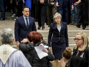 Britain's Prime Minster Theresa May and Ireland's Prime Minister Leo Varadkar leave after the funeral of the journalist Lyra McKee of St Anne's Cathedral in Belfast, northern Ireland, Wednesday April 24, 2019. The killing of journalist Lyra McKee must be a turning point for Northern Ireland, a priest said Wednesday at a funeral service attended by British and Irish leaders. (Brian Lawless/PA via AP)