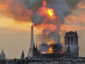 In this image made available on Tuesday April 16, 2019 flames and smoke rise from the blaze at Notre Dame cathedral in Paris, Monday, April 15, 2019. An inferno that raged through Notre Dame Cathedral for more than 12 hours destroyed its spire and its roof but spared its twin medieval bell towers, and a frantic rescue effort saved the monument's "most precious treasures," including the Crown of Thorns purportedly worn by Jesus, officials said Tuesday. (AP Photo/Thierry Mallet)