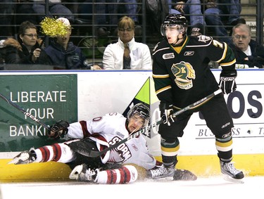 Francis Menard of the Storm goes down after a check by Matt Ashman of the Knights. The London Knights are hosting the Guelph Storm Friday night in game 5 of their playoff series at the John Labatt Centre. The Knights lead 3-1 after the first. MIKE HENSEN The London Free Press