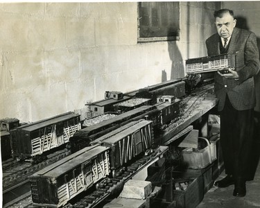 Prof. Ewart George of Philathea College, also a frustrated railway engineer, with the 'railway empire' he has built during the last 25 years in his basement at 777 Central Ave., 1965. (London Free Press files)