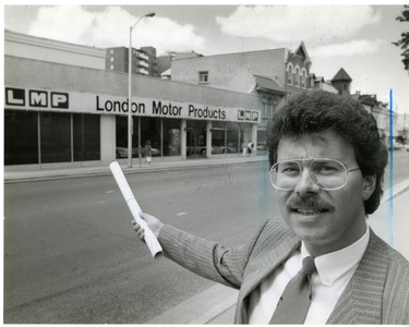 George Georgopoulos stands in front of London Motor Products site which will be developed into a Richmond Row shopping area, 1986. (London Free Press files)