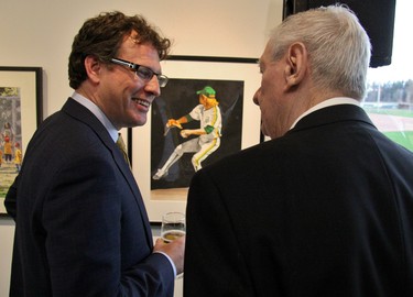 Canadian Baseball Hall of Fame chair Adam Stephens and Hall of Famer Ron Taylor look at a painting of a different Ron Taylor. (Cory Smith/Postmedia Network)