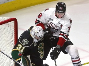 Jordan Kooy hugs the post as Guelph's Isaac Ratcliffe comes in and Kooy was able to keep the puck from moving out front.  Mike Hensen/The London Free Press file photo