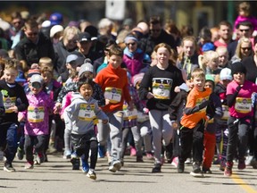 Hundreds of kids and their parents sprint off the line in the 600-metre fun run at the The Forest City Road Races in Victoria Park in April 2018. The 2022 edition -- a benefit for the Thames Valley Children's Centre -- is being moved from spring to fall. (Mike Hensen/The London Free Press)