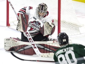 The London Knights' Alex Formenton puts a wrinkle in the sweater of Guelph Storm goalie  Anthony Popvich in the first period of their OHL game at Budweiser Gardens. (Derek Ruttan/The London Free Press)