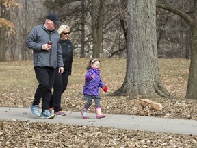 Wynn Sheppard, 4, walks her dog "Andi" accompanied by her grandfather Art Sheppard and his friend Kelly MacGregor at Springbank Park in London, Ont. on Friday March 29, 2019. Derek Ruttan/The London Free Press/Postmedia Network