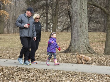Wynn Sheppard, 4, walks her dog "Andi" accompanied by her grandfather Art Sheppard and his friend Kelly MacGregor at Springbank Park in London, Ont. on Friday March 29, 2019. Derek Ruttan/The London Free Press/Postmedia Network