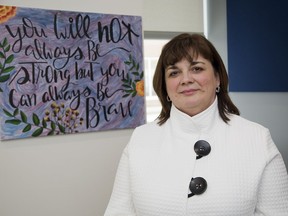 Psychiatrist Sandra Northcott stand in front of artwork done by a patient in Parkwood Institute's mental health care building. (Derek Ruttan/The London Free Press)