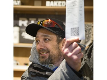 Jason Geldhof, of Goderich, shows off his receipt after making the first legal in-store purchase of marijuana in the history of London, Ont. on Monday April 1, 2019. Geldhof drove 80 minutes from his home in Goderich to be the first person in line at Central Cannabis, a store which began selling marijuana and related products Monday. Geldhof plans to frame his historic receipt. Derek Ruttan/The London Free Press