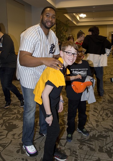 Cleveland Brownlee of the London Majors autographed a t-shirt for ten-year-old Brycen Been during the We're All Stars meet and greet portion of the London Sports Celebrity Dinner and Auction. (Derek Ruttan/The London Free Press)