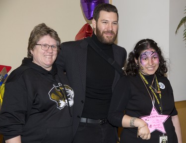 Karen McCallum (left) and Reem Terras have their photo taken with former London Knight and NHL player Brandon Prust during the We're All Stars meet and greet portion of the London Sports Celebrity Dinner and Auction. (Derek Ruttan/The London Free Press)