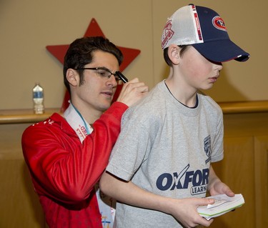 Eleven time Special Olympics gold medalist Gordie Michie autographs a t-shirt for Brenden Force of Woodstock during the We're All Stars meet and greet portion of the London Sports Celebrity Dinner and Auction. (Derek Ruttan/The London Free Press)