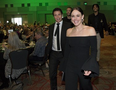 Tessa Virtue and Scott Moir enter the London Sports Celebrity Dinner and Auction followed by fellow head table guests Garrett Williamson and Mo Bolden of the London Lightning in London. (Derek Ruttan/The London Free Press)