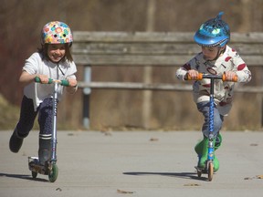 Iris Lessard-Michielsen, 6, races her scooter with Elliot Morris, 6, as they enjoy the spring weather in Gibbons Park in London, Ont.  Photograph taken on Wednesday April 3, 2019.  Mike Hensen/The London Free Press/Postmedia Network