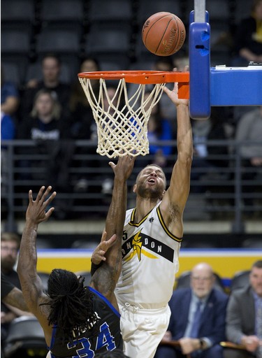 Garrett Williamson of the London Lightning lays up a two points while being harassed by Nigel Tyghter of the Kitchener-Waterloo Titans during their NBL playoff game at Budweiser Gardens in London, Ont. on Thursday April 4, 2019. Derek Ruttan/The London Free Press/Postmedia Network