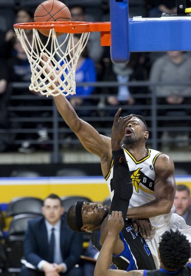 Marvin Phillips of the London Lightning goes over Flen Whitfield of the Kitchener-Waterloo Titans during their NBL playoff game at Budweiser Gardens in London, Ont. on Thursday April 4, 2019. Derek Ruttan/The London Free Press/Postmedia Network