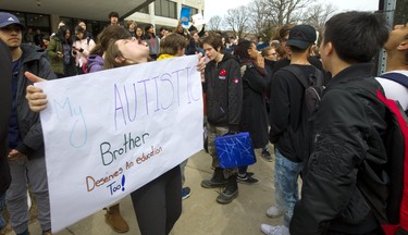 Sara Burleigh holds a sign defending her brother as Central and Beal high school students joined forces to form a large protest outside London city hall. They were protesting Premier Doug Ford's proposed education overhaul, and the demonstration grew so large London police had to disperse the crowd. Photograph taken on Thursday April 4, 2019.  Mike Hensen/The London Free Press/Postmedia Network