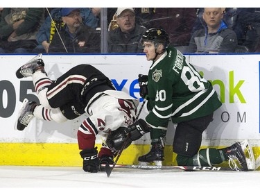Markus Phillips of the Guelph Storm pays the price after colliding with Alex Formenton of the London Knights during the first period of their OHL playoff game in London on Sunday.  (Derek Ruttan/The London Free Press)