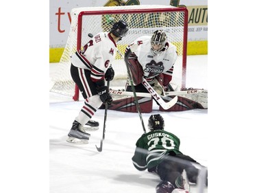 Guelph Storm defenceman Sean Durzi watches the puck go past goalie Anthony Popovich after London Knight Matey Guskov managed to get a shot off while falling during the second period of their OHL playoff game in London, Ont. on Sunday April 7, 2019.  (Derek Ruttan/The London Free Press)