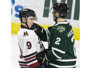 London Knights captain Evan Bouchard welcomes home native Londoner Nick Suzuki of the Guelph Storm during the second period of their OHL playoff game  in London on Sunday. (Derek Ruttan/The London Free Press)