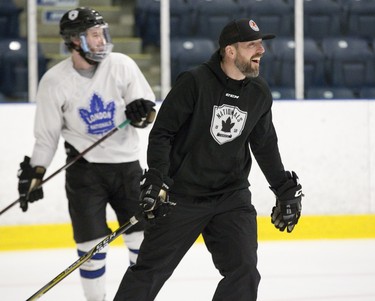 Head coach Pat Powers  and forward Zach Sheedy laugh it up during a light moment of London Nationals practice at Western Fair Sports Centre in London. Derek Ruttan/The London Free Press/Postmedia Network