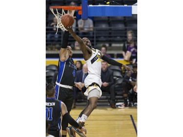 Kirk Williams Jr. of the London Lightning lays up a shot a while covered by Justin Strings of the Kitchener Waterloo Titans during their NBL playoff game in London Tuesday April 9, 2019. Derek Ruttan/The London Free Press