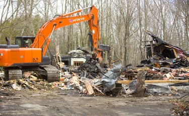 Demolition of the fire-damaged mansion at 4 Aspen Place in Lambeth went quickly on Tuesday April 9, 2019.  An excavator made short work of the damaged structure, which was gutted by fire in August 2017. Mike Hensen/The London Free Press/Postmedia Network