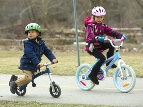 Jude Green, 3, shows off his balance bike, which allows him to be steady without worrying about pedalling. Jude was with his older sister Grace, 6, and their mom Andrea on the multi-use paths in Gibbons Park in London, Ont. Photograph taken on Wednesday April 10, 2019.  Mike Hensen/The London Free Press/Postmedia Network