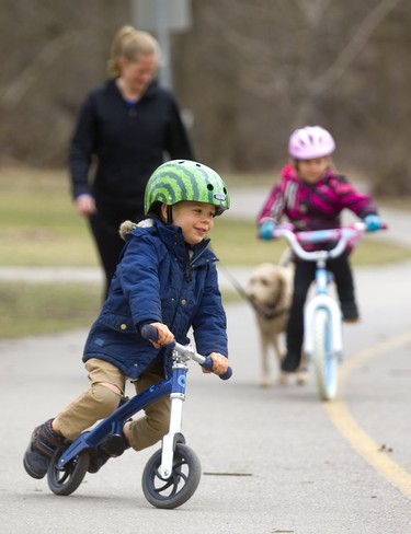 Jude Green, 3, shows off his balance bike, which allows him to be steady without worrying about pedalling. Jude was with his older sister Grace, 6, and their mom Andrea on the multi-use paths in Gibbons Park in London, Ont. Photograph taken on Wednesday April 10, 2019.  Mike Hensen/The London Free Press/Postmedia Network