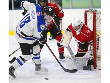 Zach Sheedy of the Nationals tries to dig a shot out of his skates as he's in tight against Evan Morrison of the Listowel Cyclones during a semifinal game in London. (MIKE HENSEN, Free Press file photo)