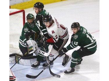 Jordan Kooy gets run over by his own defenceman Riley Coome and Keegan Stevenson of the Guelph Storm with Alex Turko of the Knights coming back to check during first period action at Budweiser Gardens on Friday in Game 5 of the playoff series. (Mike Hensen/The London Free Press)