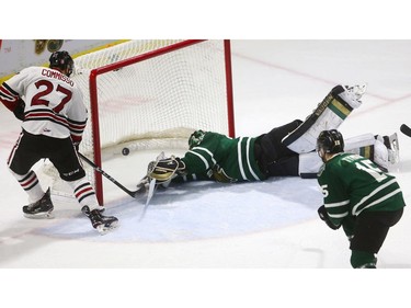 Domenico Commisso of the Guelph Storm sneaks a puck under the outstretched stick of Knights goalie Jordan Kooy for the first goal of the game during first period action at Budweiser Gardens on Friday in Game 5 of the playoff series. (Mike Hensen/The London Free Press)
